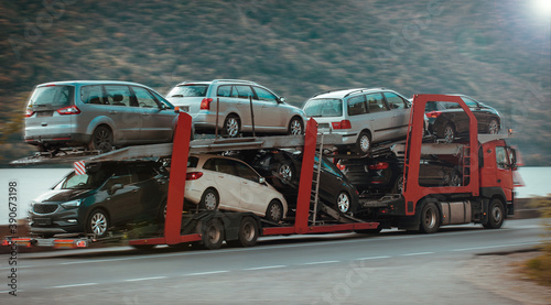 Car carrier in motion. Auto industry, cars export- concept.