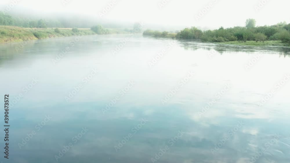 Video from a drone, fog on the river in summer at sunrise, pine trees, sand Video from a drone, fog on the river in summer at sunrise, pine trees, sand
