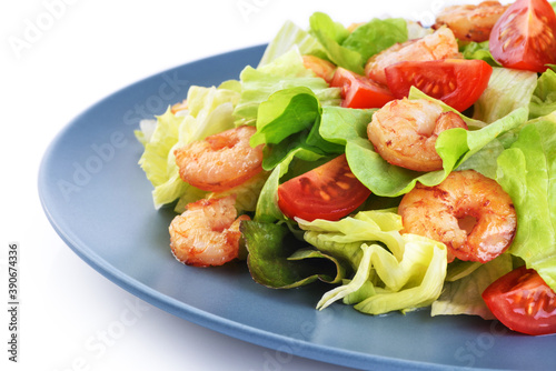 Caesar salad with shrimp lettuce and tomato on a white background.