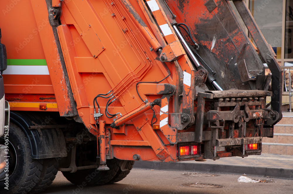 a garbage truck collects rubbish in the yards of a residential area a garbage truck collects rubbish in the yards of a residential area