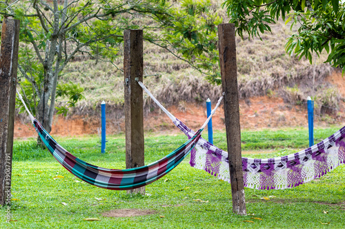 Colorfull hammoks among trees on a farm photo