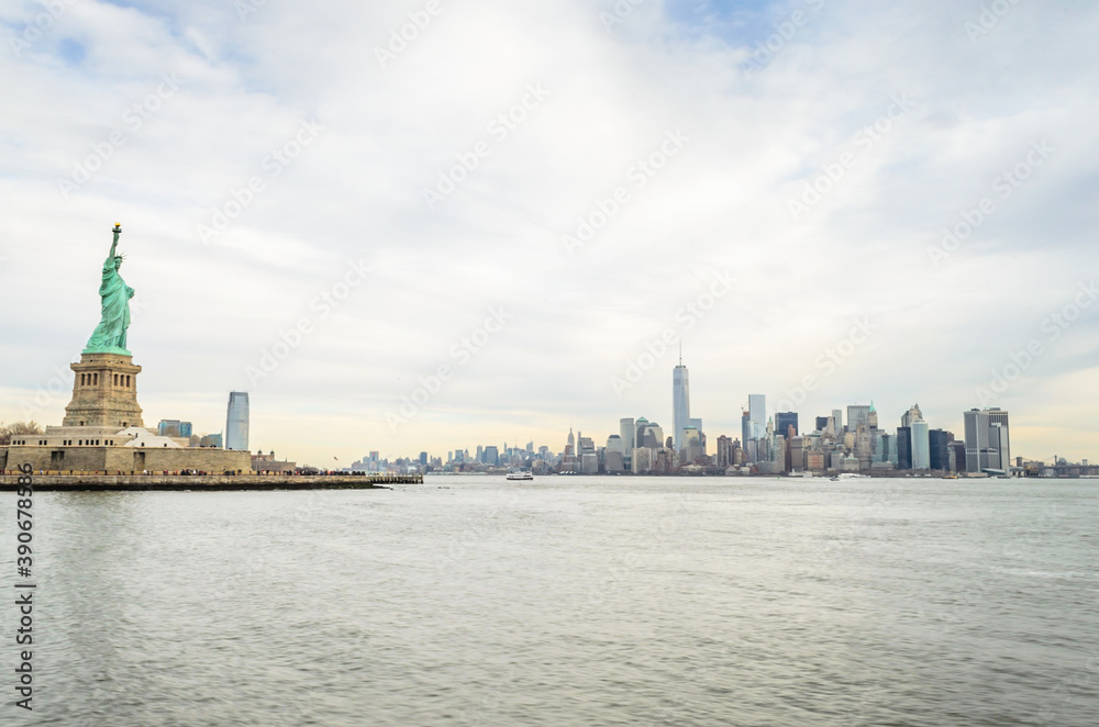 Lady Liberty Statue with Lower Manhattan Futuristic Buildings and Towers in Background. New York City, USA Lady Liberty Statue with Lower Manhattan Futuristic Buildings and Towers in Background. New York City, USA