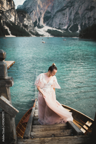 Beauty portrait of bride wearing fashion wedding dress with feathers with luxury delight make-up and hairstyle © olegparylyak