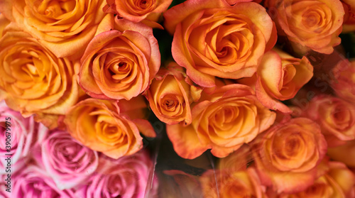 Beautiful bouquets of red  pink and yellow roses in a flower shop. A bright mix of flowers. Handsome fresh bouquets. Flowers delivery. Floral shop concept. Selective focus.