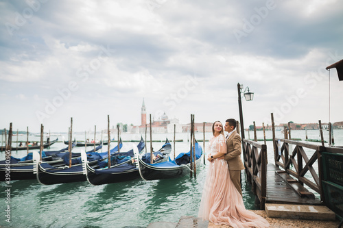Wedding couple on the nature is hugging each other. Beautiful model girl in white dress. Man in suit.Venice, Italy © olegparylyak