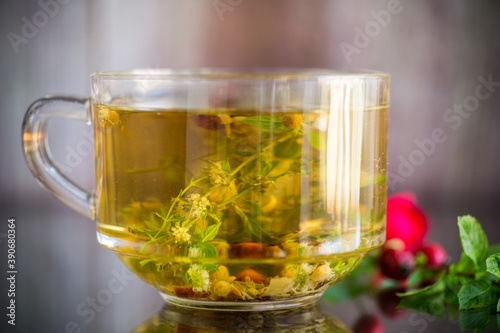 natural hot tea from various summer herbs in a glass cup