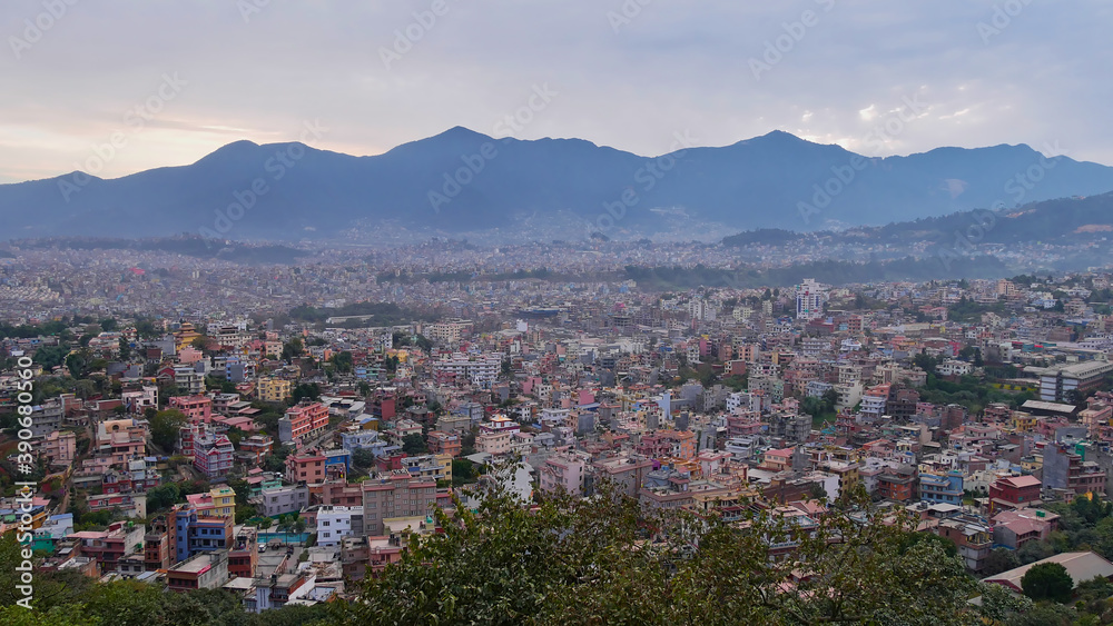 Panorama view over the west of densely populated Kathmandu, Nepal with Himalaya foothills (Chandragiri Hills) in background viewed from historic Buddhist temple complex Swayambhunath.