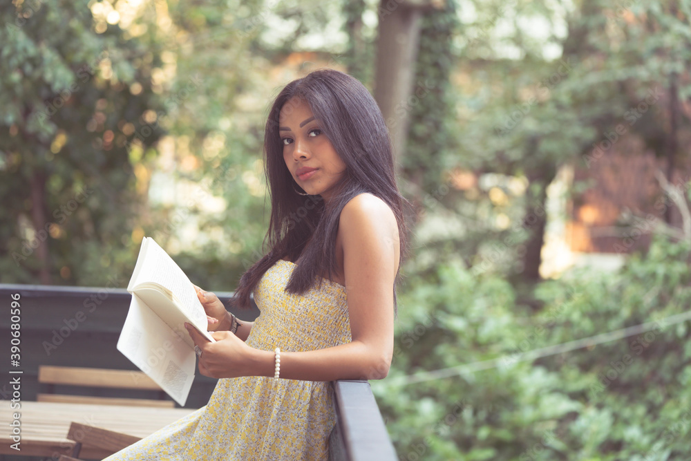 relaxed girl with a book in her hand thinking relaxed girl with a book in her hand thinking