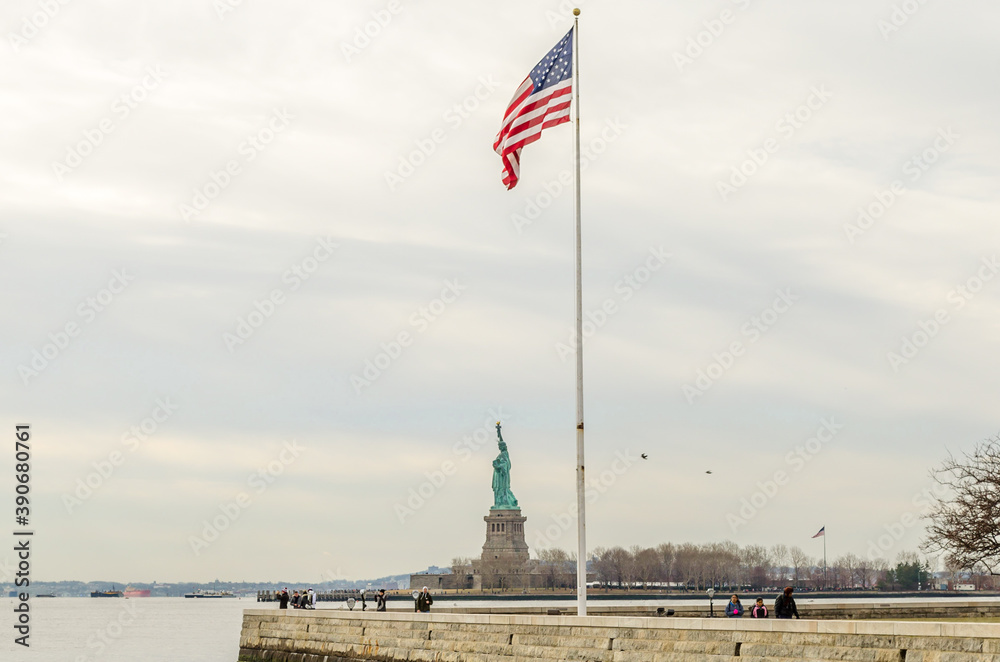 Fototapeta premium United States of America Flag and Statue of Liberty Enlightening the World. New York City, USA