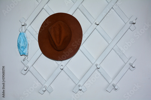 Obraz na plátně Hallway cloakroom with a blue protective mask and a hat