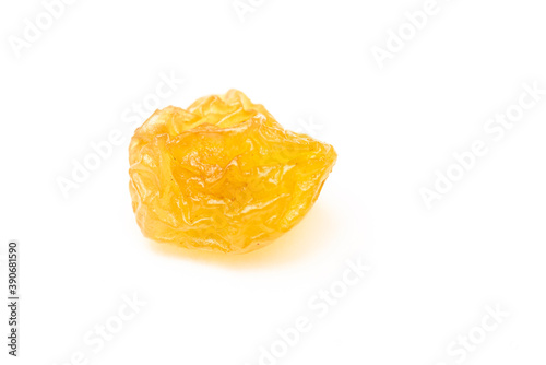Closeup of yellow raisins on a white background