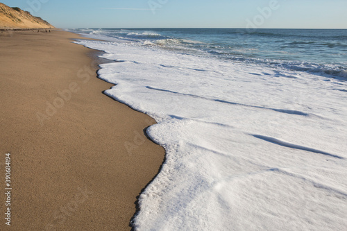 Close-up of seafoam waves lapping the beach sand at Whitecrest Beach photo