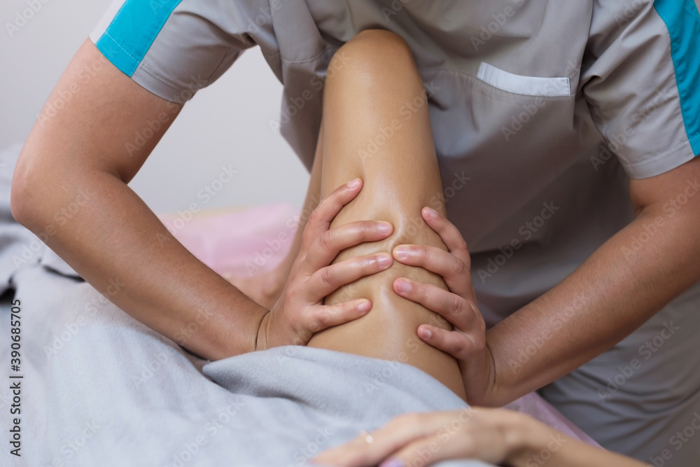 Caucasian woman getting a leg massage in the spa salon. Body care concept. Special anticellulite treatment. Caucasian woman getting a leg massage in the spa salon. Body care concept. Special anticellulite treatment.