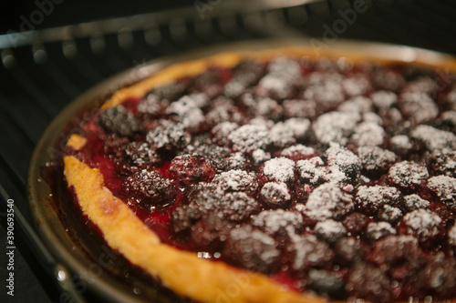 Autumn berry pie with powdered sugar