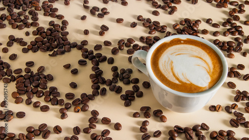 Obraz na płótnie Cappuccino with a beautiful pattern on the milk foam in a white cup on the table cream color and scattered around the roasted coffee beans w salonie
