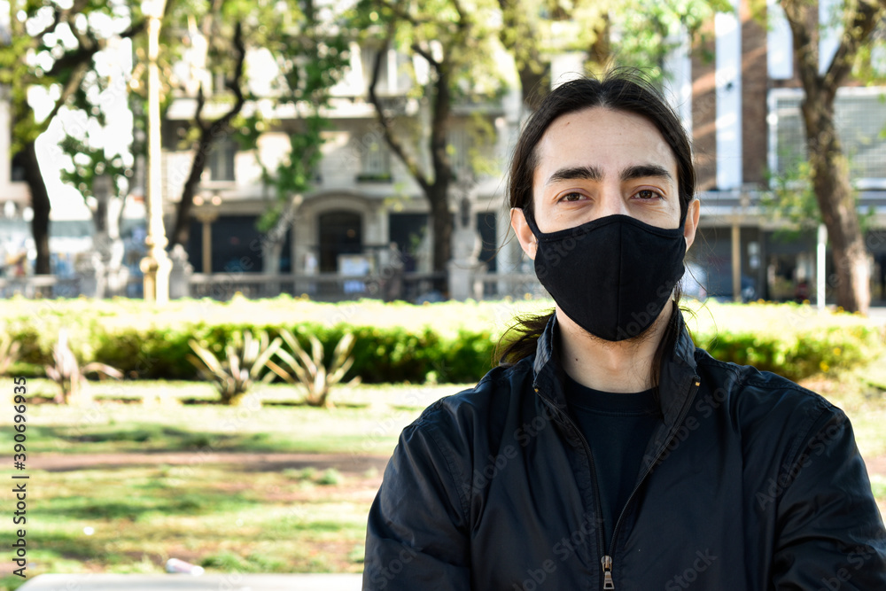 young man with mask in the city park young man with mask in the city park