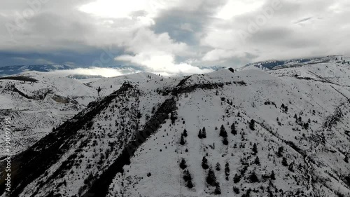 Drone Hyper-lapse: Ariel Winter Peaks covered in snow photo