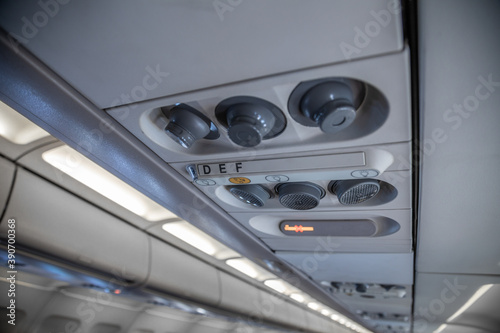 air conditioning system of an airplane overhead regulator to control the temperature and the flowing of the oxygen while smoking permission sign is light up