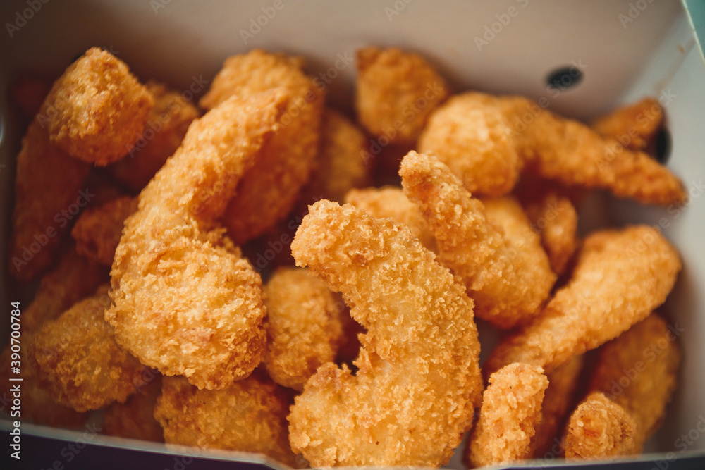 Fried shrimps in white striped fast food box Fried shrimps in white striped fast food box
