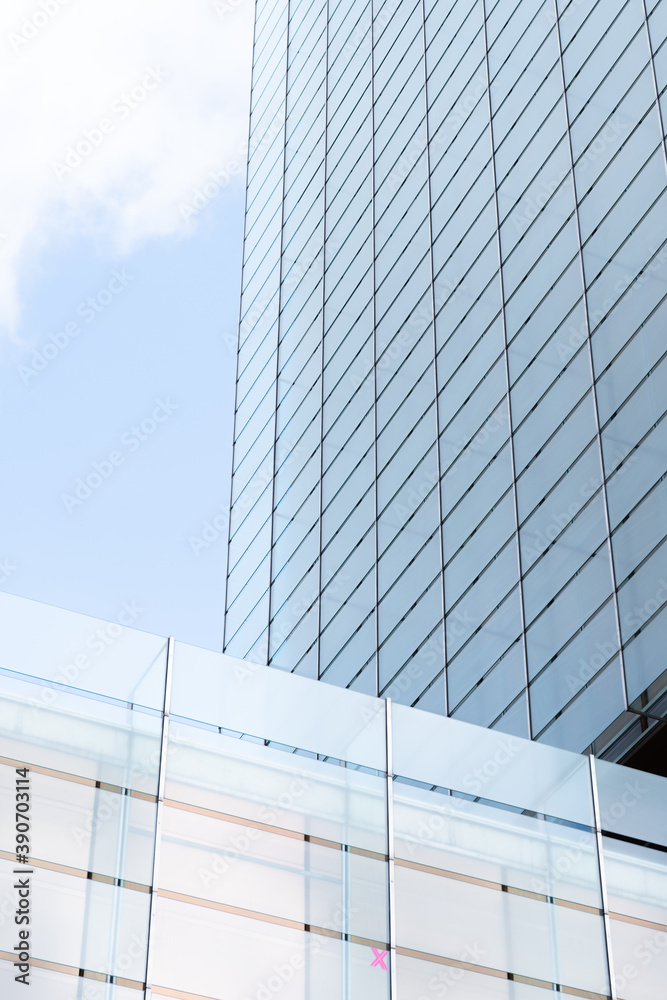 Obraz premium windows with reflection of clouds and blue sky in industrial and colorful business buildings