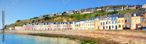 Promenade near colorful houses, white cliffs and English Channel on a clear day. Fécamp, Normandy, France. Blue sky, azure water. Nature, history, past, landmark, sightseeing, travel. Panoramic view photo