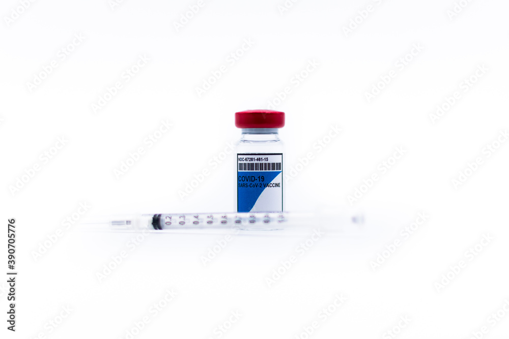 COVID-19 vaccine vial with a syringe on white background with selective focus. Healthcare And Medical concept COVID-19 vaccine vial with a syringe on white background with selective focus. Healthcare And Medical concept
