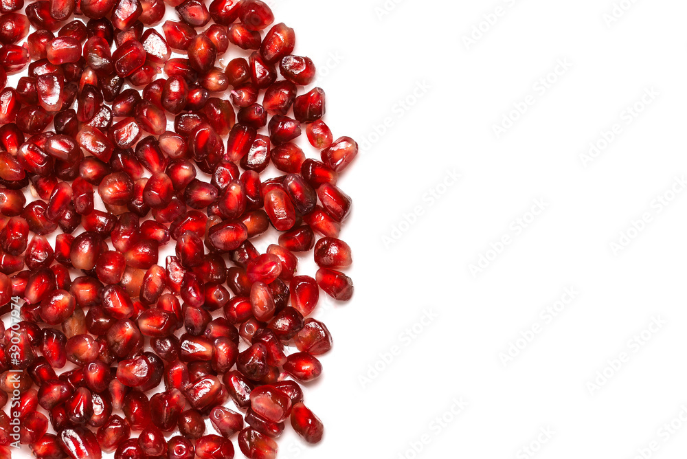 Ripe pomegranate seeds isolated on white background with copy space. Top view, flat lay. Ripe pomegranate seeds isolated on white background with copy space. Top view, flat lay.