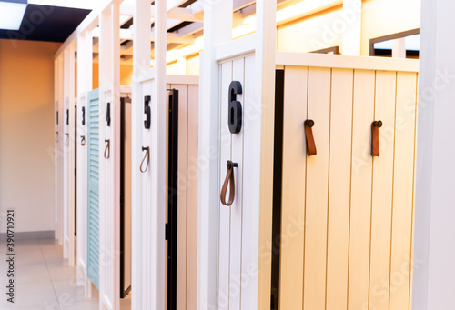 Wooden dressing booths for trying on clothes from the store. Clean, bright, comfortable and empty fitting rooms