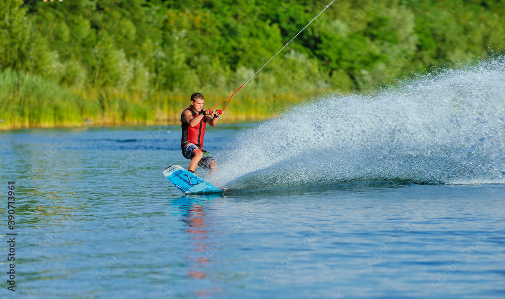 Wakeboarder surfing across a lake Wakeboarder surfing across a lake