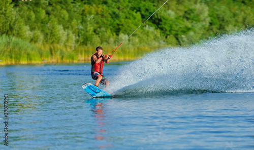 Wakeboarder surfing across a lake