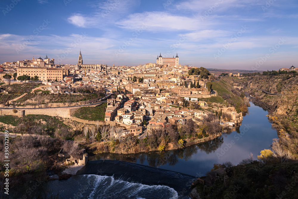 Beautiful view of Toledo city skyline with Cathedral, Alcazar and Tagus River with blue sky and clouds, Spain