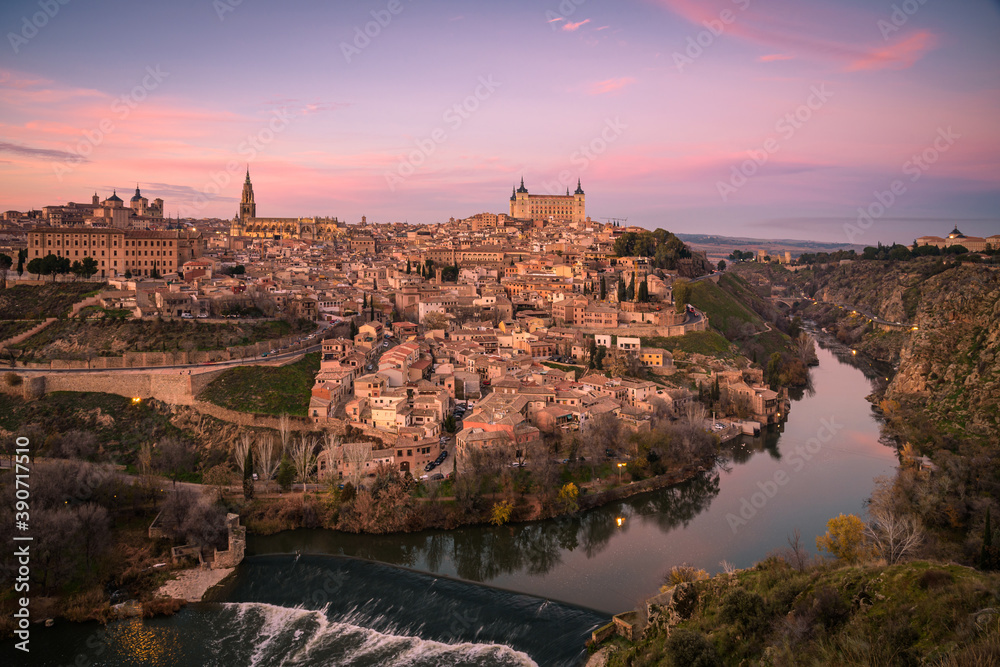 Beautiful view of Toledo city skyline with Cathedral, Alcazar and Tagus river at sunset, Spain