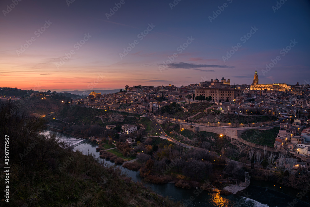 Beautiful view of Toledo city skyline with Cathedral and Tagus river at sunset, Spain