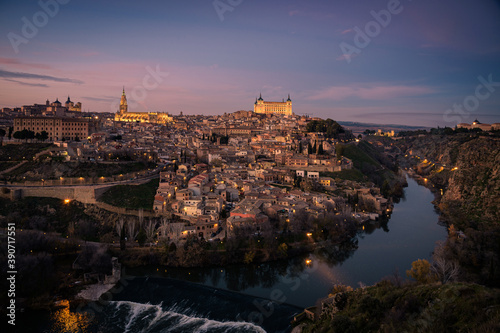 Beautiful view of Toledo city skyline with Cathedral, Alcazar and Tagus river at sunset, Spain