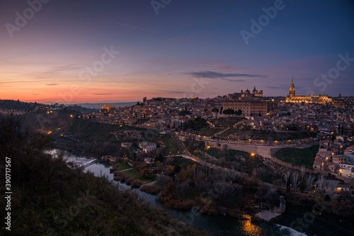 Beautiful view of Toledo city skyline with Cathedral and Tagus river at sunset, Spain