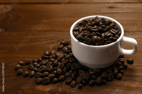 Tasty roasted coffee grains in mug