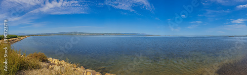 Panorama of the Ebro delta landscape with water and blue sky