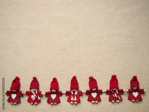 christmas card, little red elfs with white heart on dress and knitted hat on white background, winter background