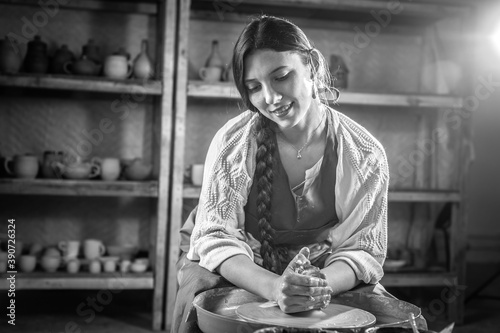 Processing clay ware and making dishes, process. Ceramics of handwork and clay ware on the potter's wheel. photo