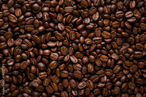 coffee beans background. Overhead macro shot of coffee seeds. Flat lay of the roasted coffee beans