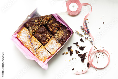 A box of homemade apple lavender blondies and brownie cookies on the white background. Flat lay