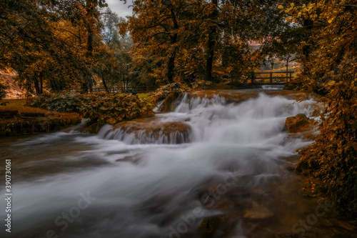 Fototapeta Naklejka Na Ścianę i Meble -  A flowing water of the mountain river in picturesque Rastoke village in Croatia. August 2020, long exposure picture.