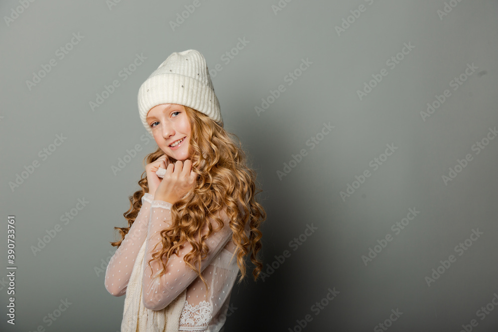 Cute blonde teen girl in white cap on grey background Cute blonde teen girl in white cap on grey background
