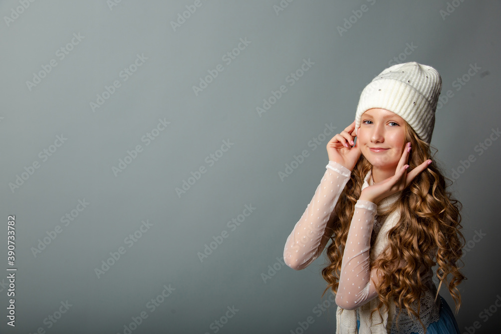 Cute blonde teen girl in white cap on grey background Cute blonde teen girl in white cap on grey background