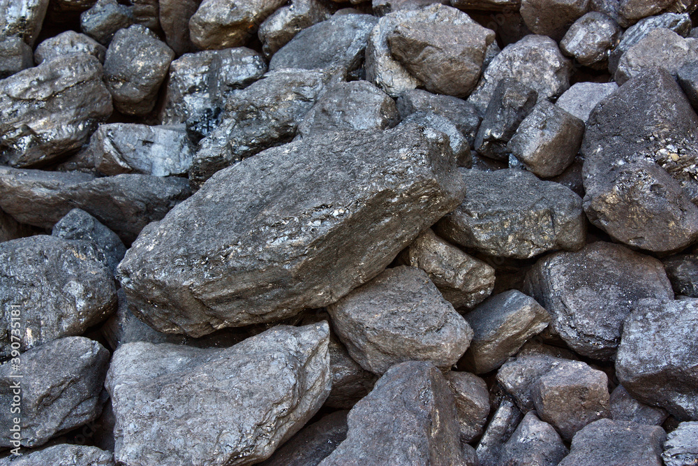 Pile of coal from mine deposit of black mineral stones