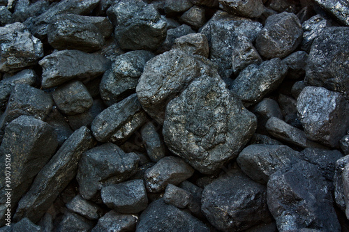 Pile of coal from mine deposit of black mineral stones