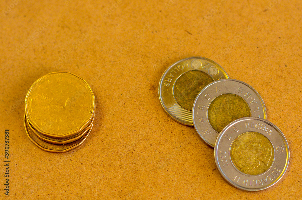 Canadian Currency With A Yellowish Background Pile Of Golden Coin canadian-currency-with-a-yellowish-background-pile-of-golden-coin