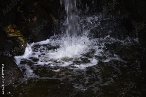 Fototapeta Naklejka Na Ścianę i Meble -  A small waterfall in a natural park.