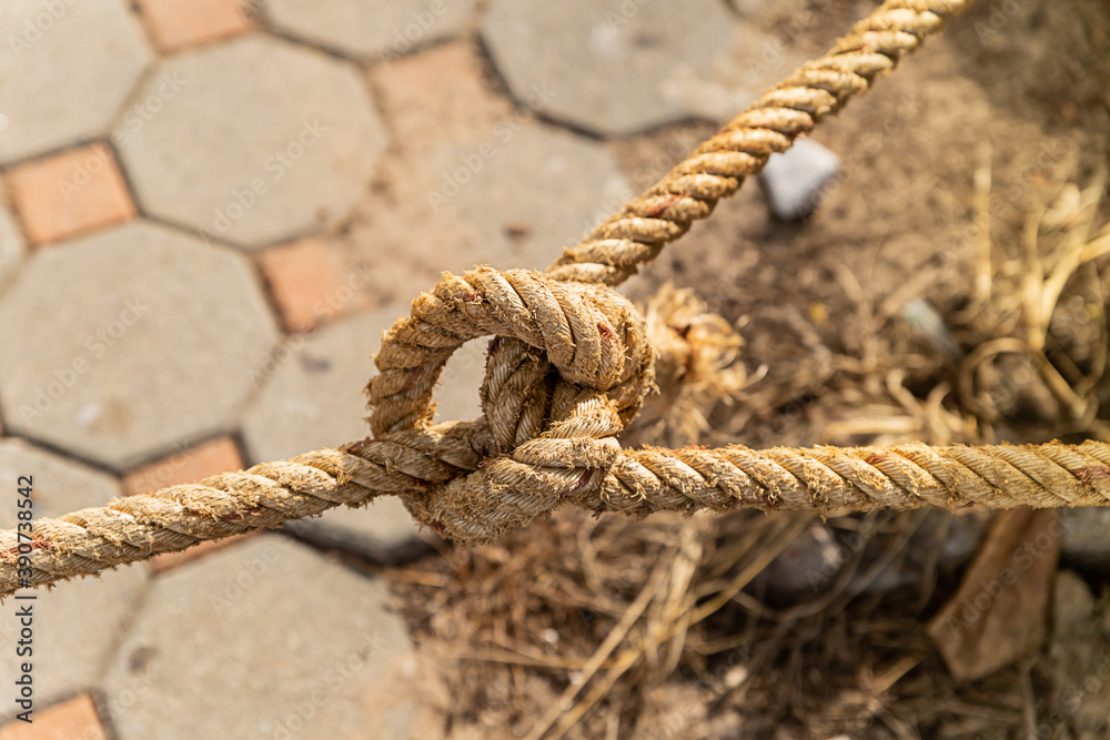 Fototapeta premium nautical knot from old and weathered rope closeup part of a mooring cable