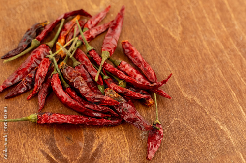dried hot red pepper bunch on wooden background seasoning